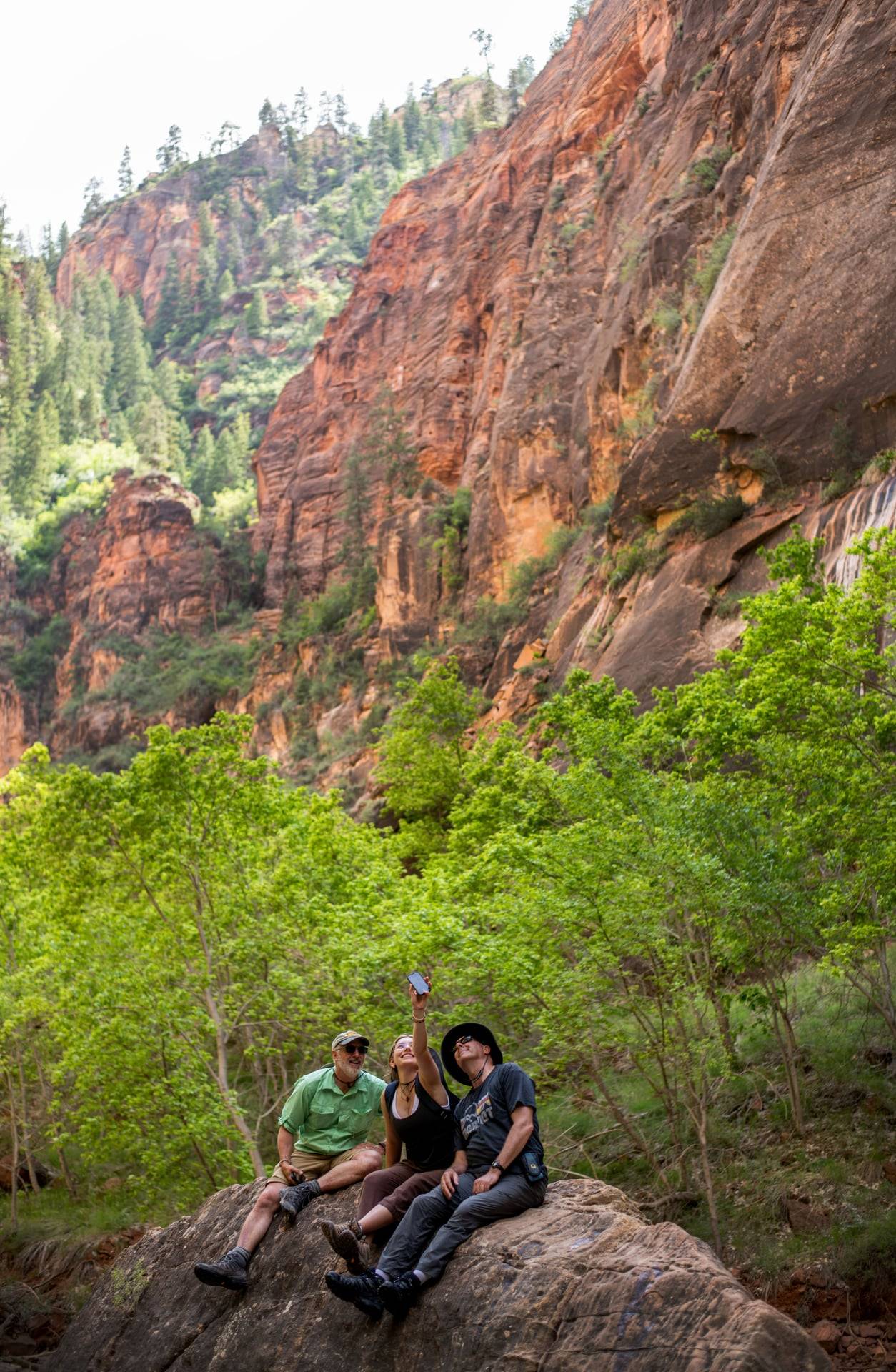 Peter Riemersma and Peter Wampler speak with a student next to a river during Water in the West